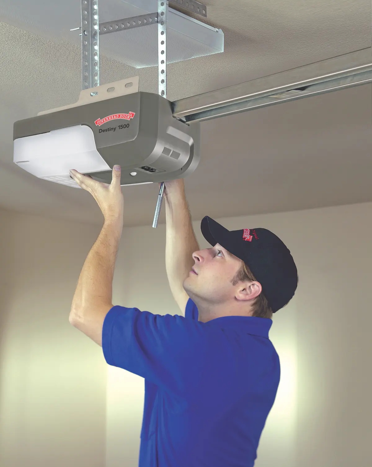 A technician installing a garage door opener